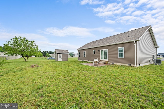 rear view of property with a patio, a yard, central AC unit, and a shed