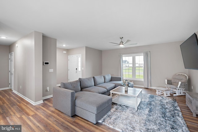 living room featuring dark hardwood / wood-style floors and ceiling fan