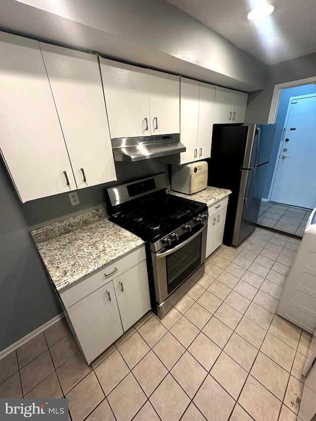 kitchen featuring white cabinetry, light tile patterned floors, and appliances with stainless steel finishes