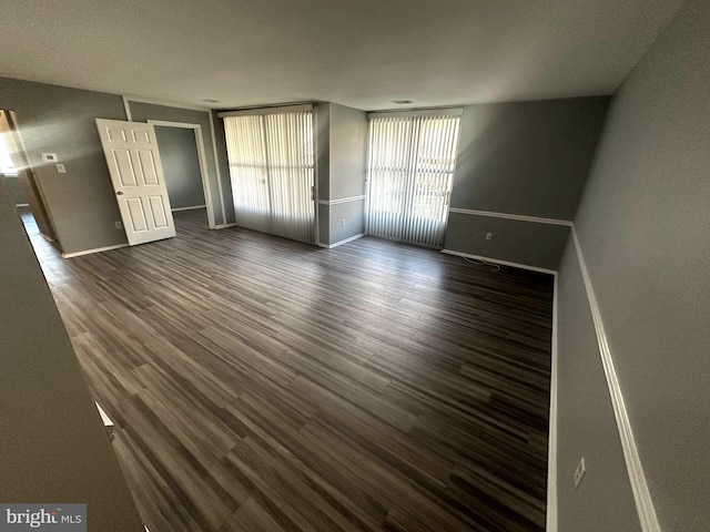 spare room featuring dark wood-type flooring