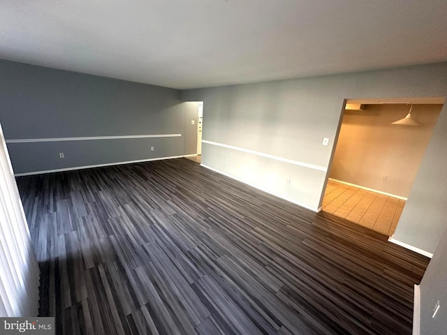 unfurnished room featuring dark hardwood / wood-style floors