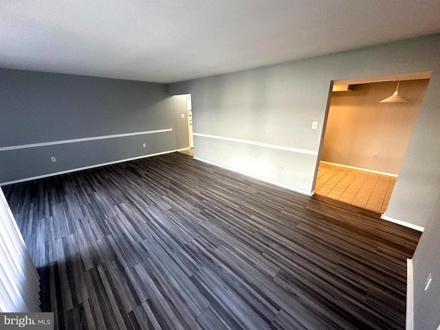 spare room featuring dark hardwood / wood-style flooring