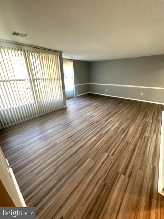 spare room with dark wood-type flooring