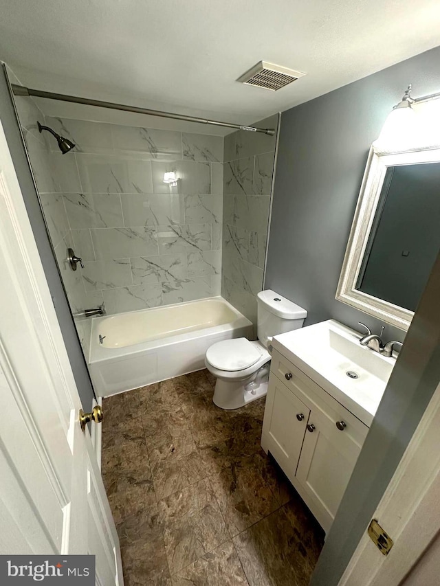 full bathroom with vanity, toilet, and tiled shower / bath