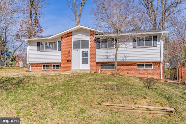 bi-level home featuring a front yard and a sunroom