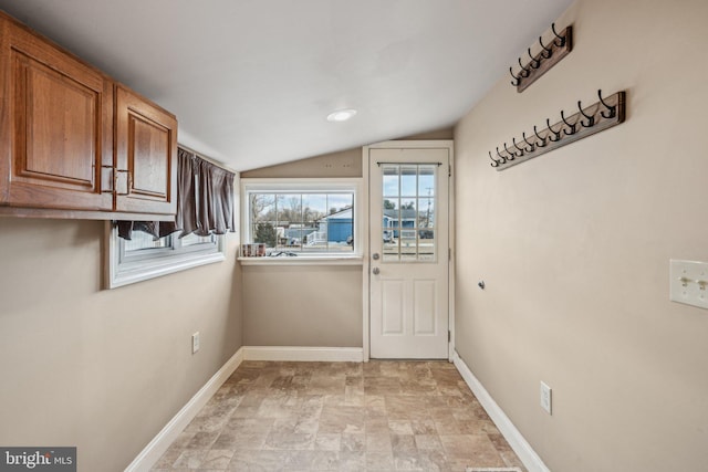 clothes washing area with cabinets