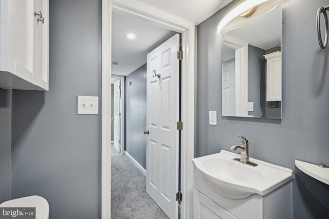 bathroom featuring vanity and toilet