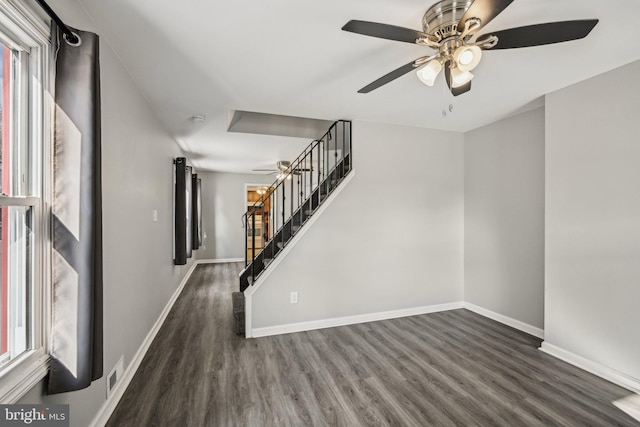 interior space featuring ceiling fan and dark hardwood / wood-style flooring