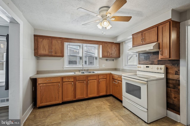 kitchen featuring sink, white electric range oven, a textured ceiling, and ceiling fan