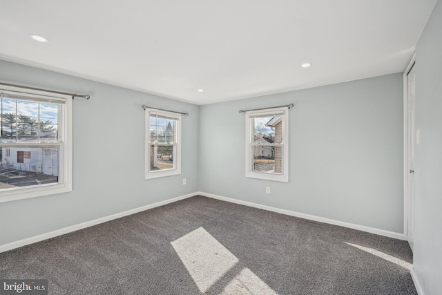 carpeted empty room with plenty of natural light