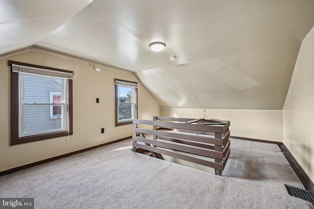 bonus room with lofted ceiling and carpet