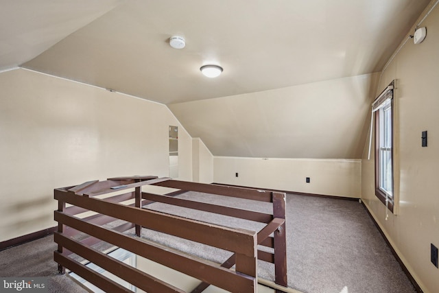 carpeted bedroom with lofted ceiling