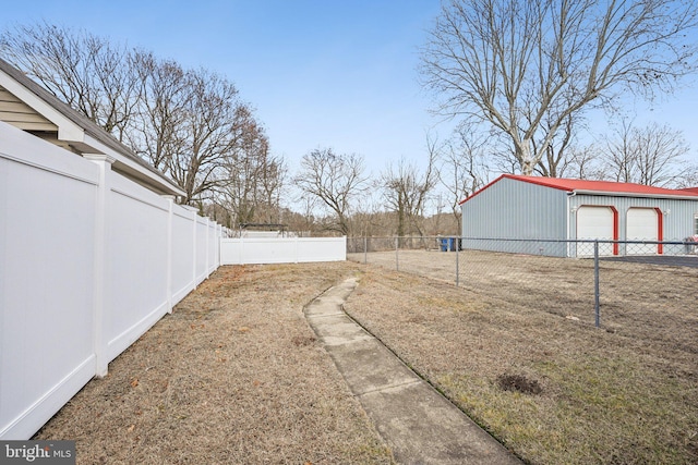 view of yard featuring an outbuilding and a garage