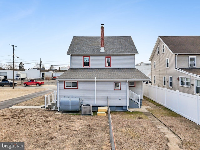 back of house featuring central air condition unit