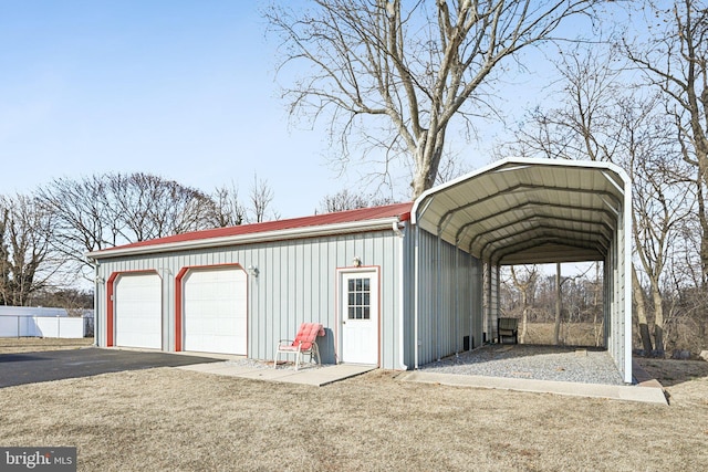 view of outdoor structure featuring a garage and a carport