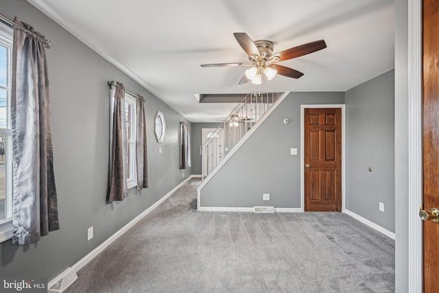 empty room with ceiling fan and carpet