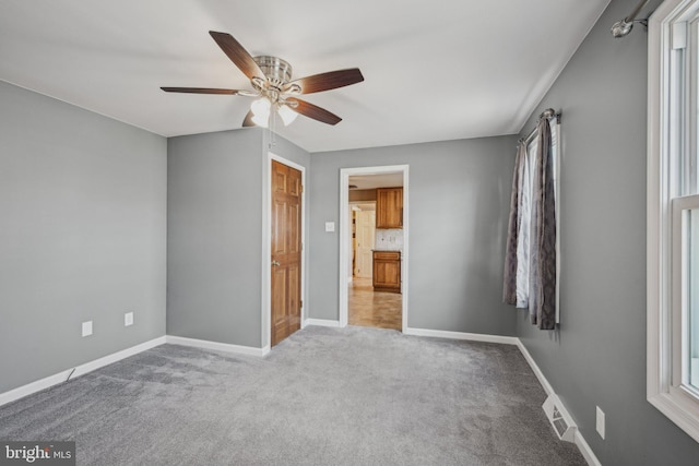 unfurnished bedroom with ceiling fan and light carpet