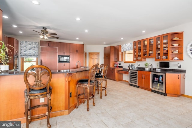 kitchen with wine cooler, a healthy amount of sunlight, and built in appliances