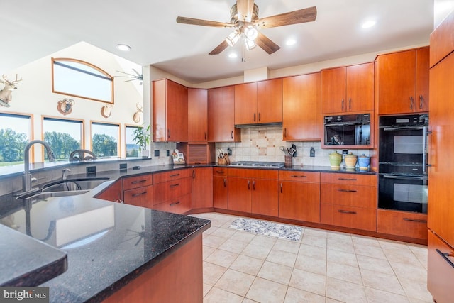 kitchen featuring double oven, sink, backsplash, stainless steel gas cooktop, and ceiling fan