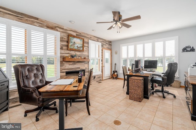 tiled home office featuring ceiling fan and a healthy amount of sunlight