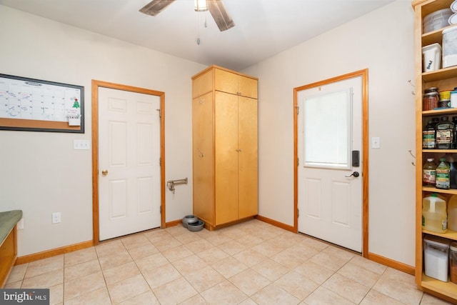 tiled foyer with ceiling fan