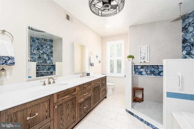 bathroom with tile patterned flooring, vanity, toilet, and walk in shower