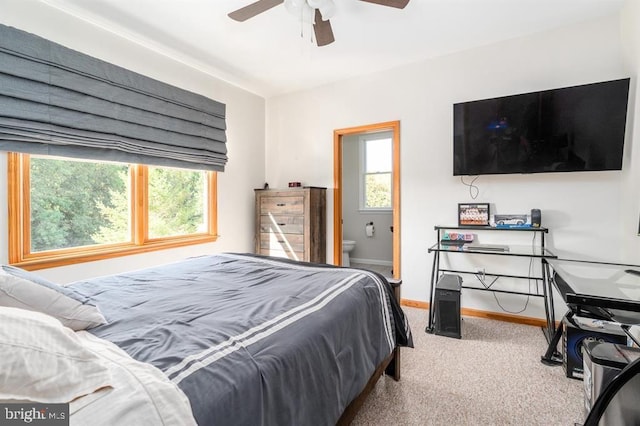 carpeted bedroom featuring connected bathroom and ceiling fan