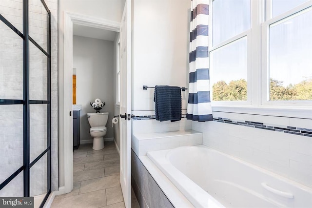 bathroom with tile patterned floors, toilet, and separate shower and tub