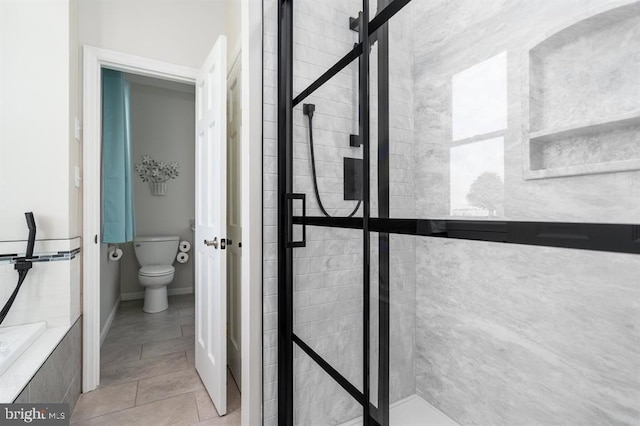 bathroom featuring tile patterned flooring and toilet