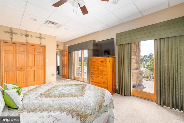 bedroom with carpet, a drop ceiling, access to exterior, and ceiling fan