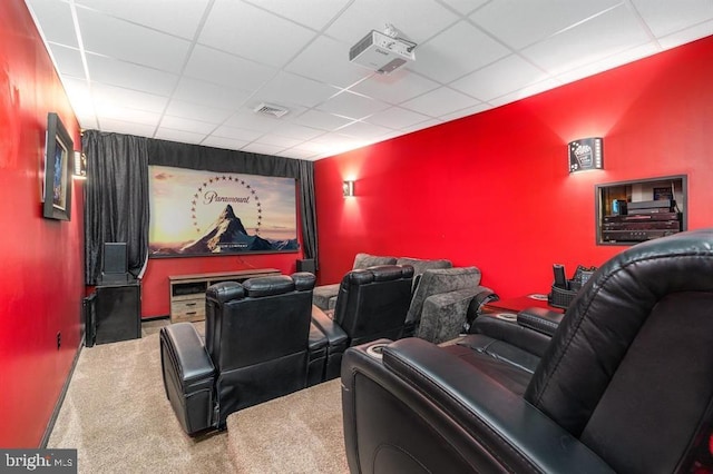 cinema room featuring carpet and a paneled ceiling