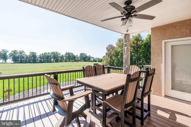 wooden deck with a rural view and ceiling fan