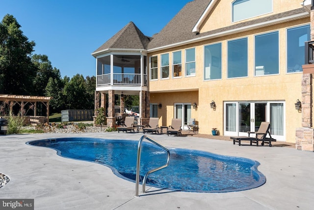 rear view of property with a patio area, ceiling fan, and a pergola