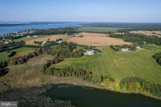 birds eye view of property with a water view and a rural view