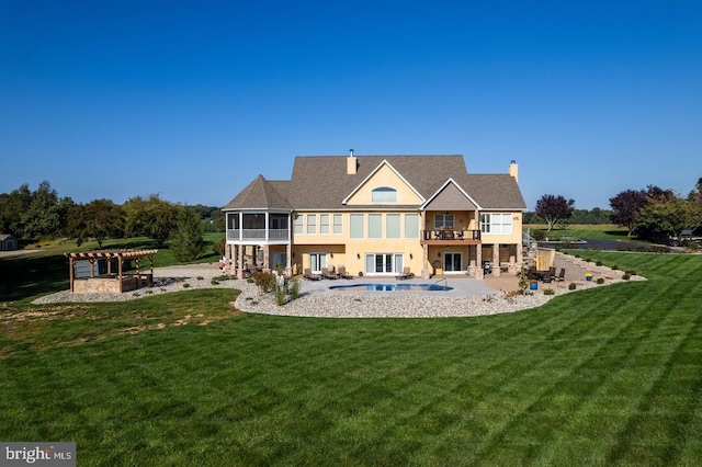 back of property with a yard, a pergola, a patio, a sunroom, and a balcony