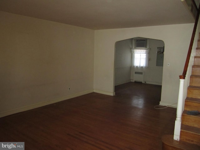 unfurnished room featuring radiator and dark wood-type flooring