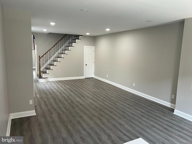 basement with dark hardwood / wood-style flooring