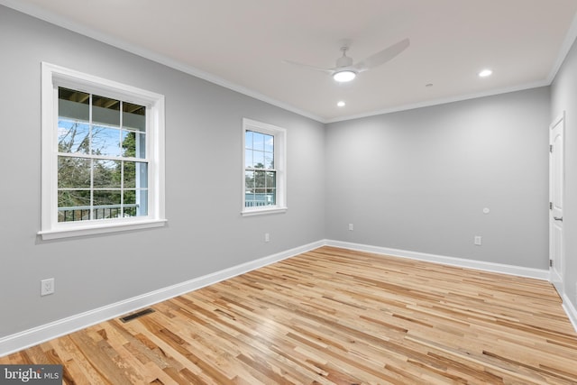 unfurnished room featuring light wood-type flooring, crown molding, baseboards, and a ceiling fan