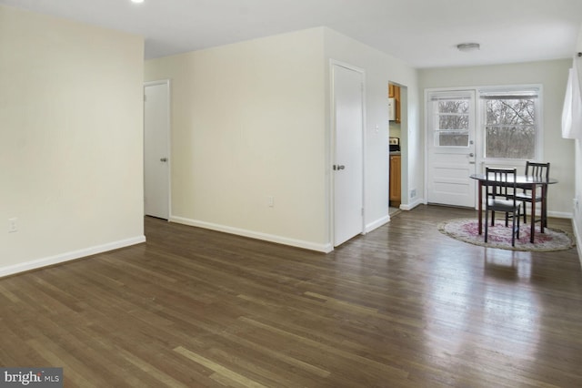 interior space featuring dark wood-style floors and baseboards