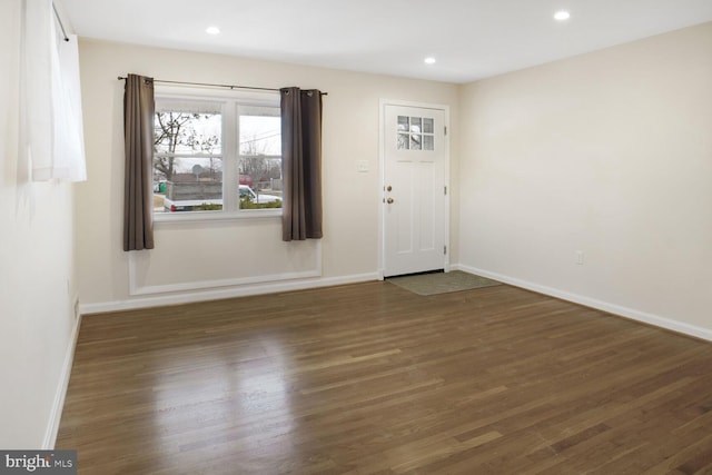 entrance foyer with recessed lighting, dark wood finished floors, and baseboards