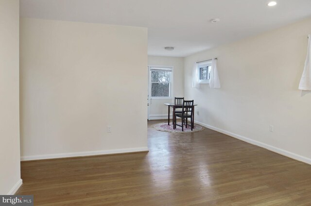 empty room with dark wood-style floors and baseboards