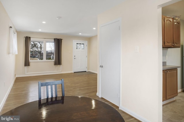 foyer featuring baseboards and light wood-style floors