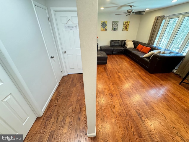 unfurnished living room with ceiling fan and hardwood / wood-style floors