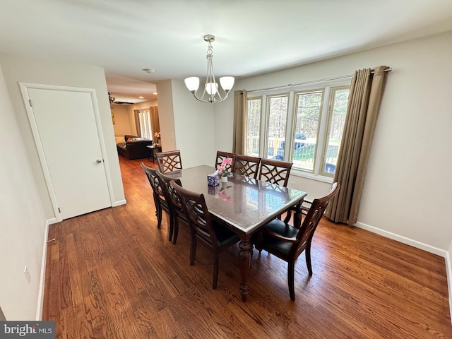 dining space featuring a notable chandelier and dark wood-type flooring