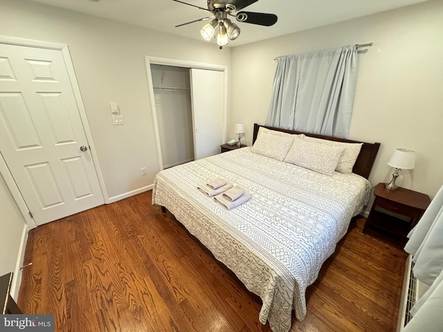 bedroom with dark hardwood / wood-style floors, ceiling fan, and a closet