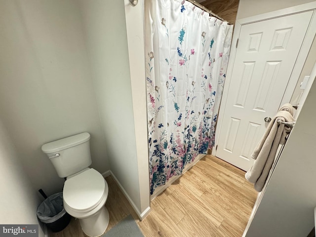 bathroom with toilet and hardwood / wood-style floors