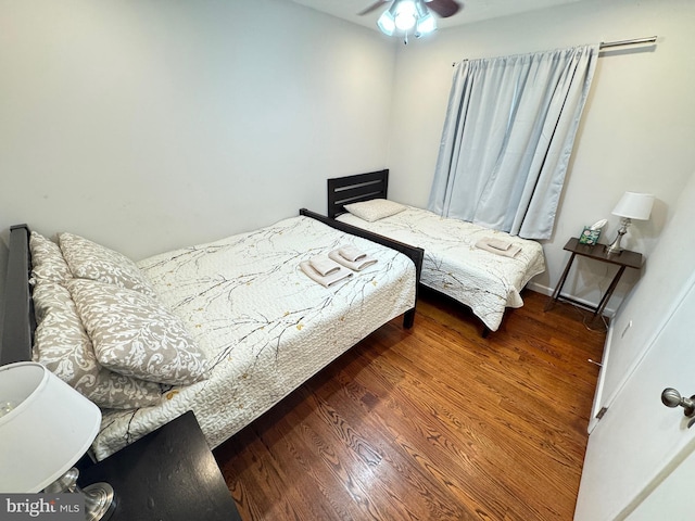 bedroom with ceiling fan and dark hardwood / wood-style flooring