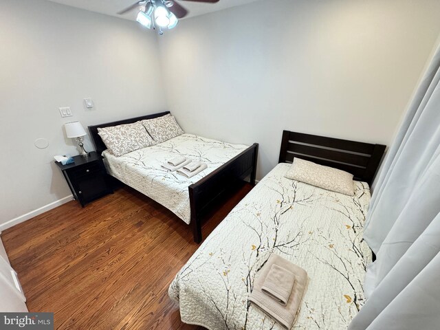 bedroom with dark hardwood / wood-style flooring