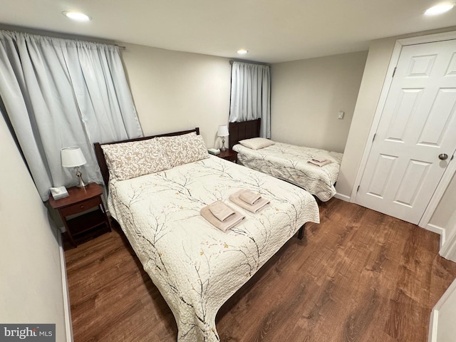 bedroom with dark hardwood / wood-style floors