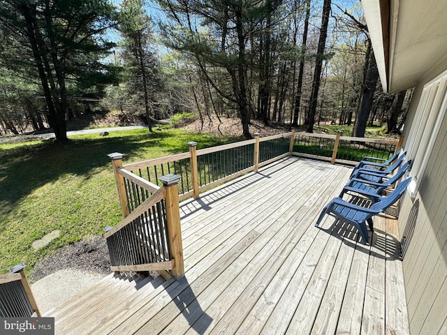 wooden deck with a lawn